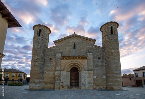 Facade of the Romanesque church of San Martín de Tours in Frómista, Palencia, Castilla y León, Spain with sunrise light and spectacular sky photo