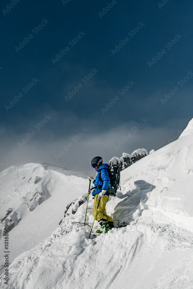 Skier rides in big rocky off-piste. Skier rides in big rocky off-piste.