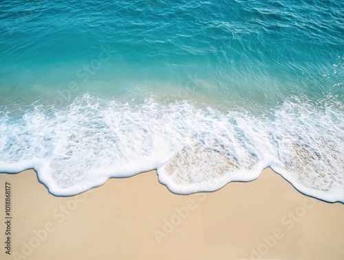 Gentle waves lapping the soft sandy beach under a bright blue sky