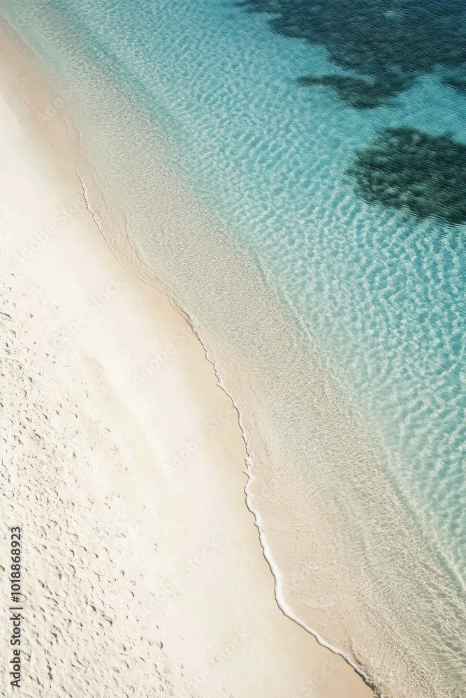 Fototapeta Tranquil beach setting with lounge chairs and umbrellas along a clear turquoise coastline