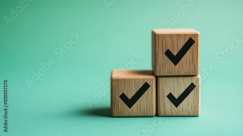 Checklist concept with copy space. Wood cubes with check marks on green background. photo