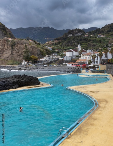 Swimmingpool at coast Porto da Cruz Madeira. Ocean. Mountains.