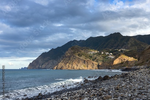 Ocean coast and beach and moutains at sunset. Porto da Cruz Madeira. 