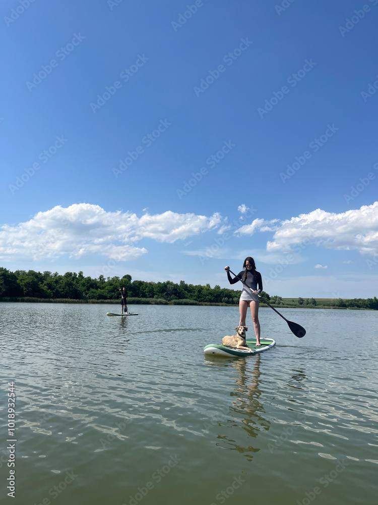 Friends With a Dog SUP Paddle Boarding on a Lake Friends With a Dog SUP Paddle Boarding on a Lake