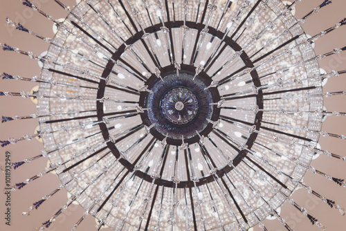 A chandelier bottom view with ceiling background. A low angle shot of a crystal chandelier.  photo