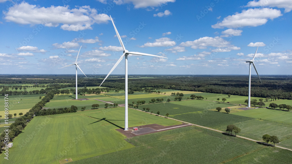 Landscape photo of three wind turbines in meadow farming field. Green renewable energy, global warming, climate change, sustainability, farm land concept. Landscape photo of three wind turbines in meadow farming field. Green renewable energy, global warming, climate change, sustainability, farm land concept.