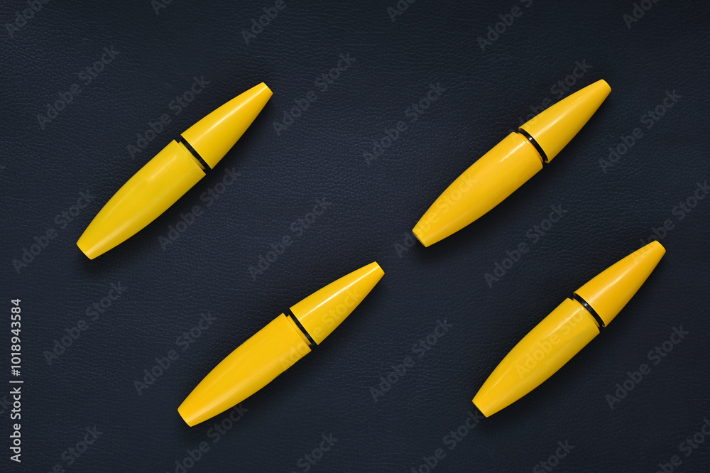 mascara for eyelashes yellow pattern on a black background fly lay mascara for eyelashes yellow pattern on a black background fly lay