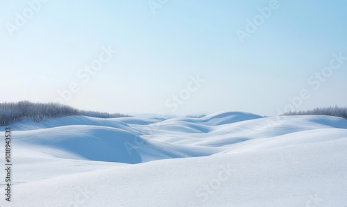 Winter landscape with rolling snow-covered hills under a clear, pale blue sky