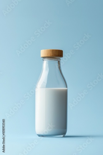 Full glass milk bottle with a wooden cap on a blue background, evoking freshness and purity.