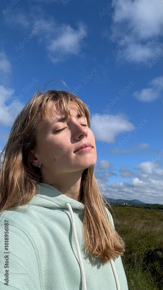 A UGC selfie of a woman over blue sky A UGC selfie of a woman over blue sky