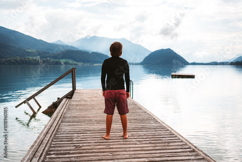 boy standing on jetty photo