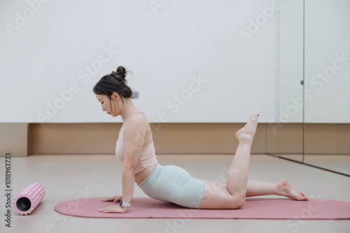 Woman Practicing Yoga in a Modern Studio photo