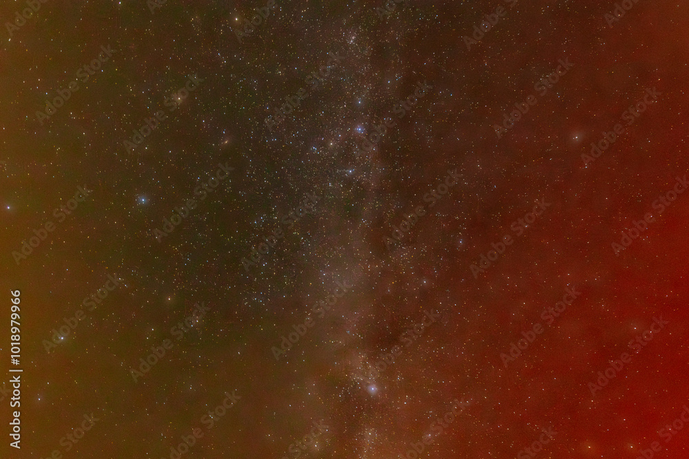 A mesmerizing night sky filled with countless stars and a subtle nebula, displaying a gradient of colors from red to green. The scene captures the vastness and beauty of the universe. A mesmerizing night sky filled with countless stars and a subtle nebula, displaying a gradient of colors from red to green. The scene captures the vastness and beauty of the universe.