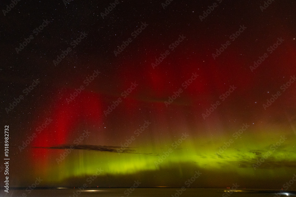 A stunning display of red and green auroras lighting up the night sky, with stars sparkling in the background. The vibrant celestial event creates a mesmerizing, ethereal atmosphere. A stunning display of red and green auroras lighting up the night sky, with stars sparkling in the background. The vibrant celestial event creates a mesmerizing, ethereal atmosphere.