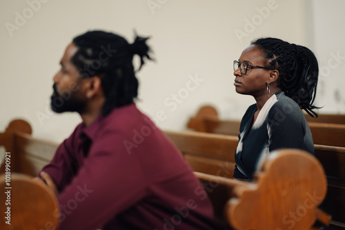 People sitting in church pew attending religious service photo