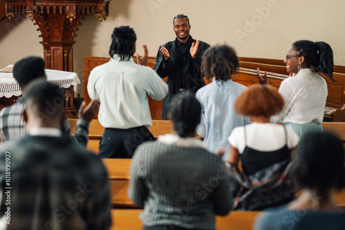 Fotografía Congregation clapping while pastor is preaching in church