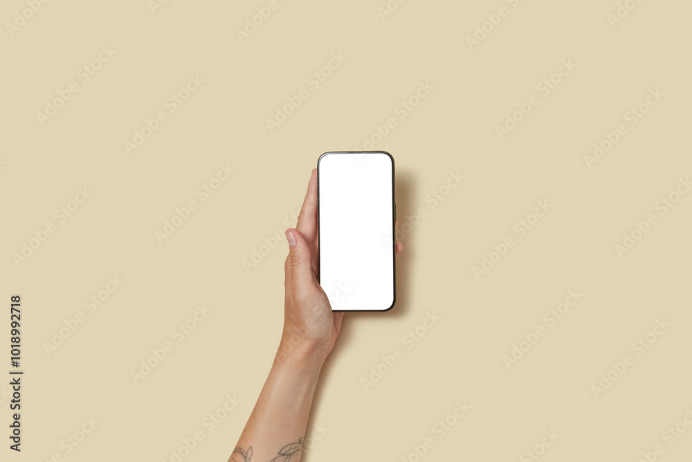 © Yaroslav Danylchenko/Stocksy - Faceless human keeping cellphone with blank white screen in arm