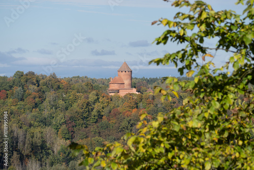 Turaida castle in autumn forest on hilltop photo