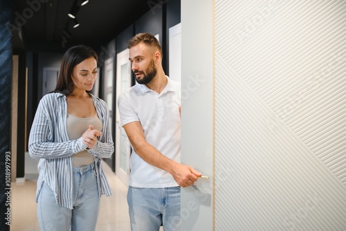 A married couple chooses new interior doors for their home at a hardware store photo