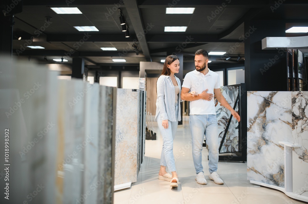 Young married couple chooses tiles for their home together Young married couple chooses tiles for their home together