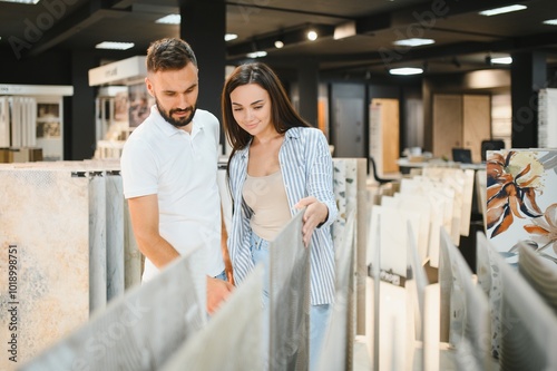 Married couple chooses ceramic tiles for kitchen or bath at a hardware store photo