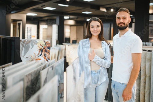 Married couple chooses ceramic tiles for kitchen or bath at a hardware store photo