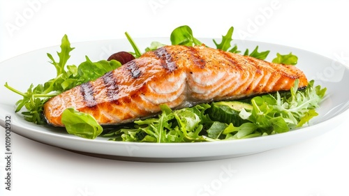 Grilled salmon fillet on a bed of fresh leafy greens with cucumber and grape accents