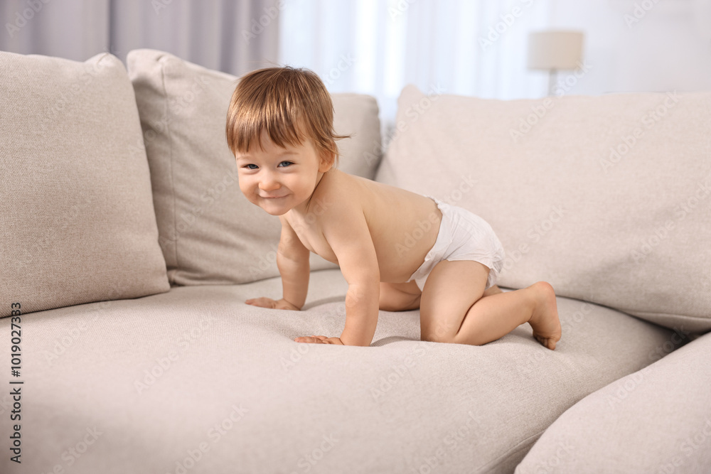 Little child in diaper on sofa at home Little child in diaper on sofa at home