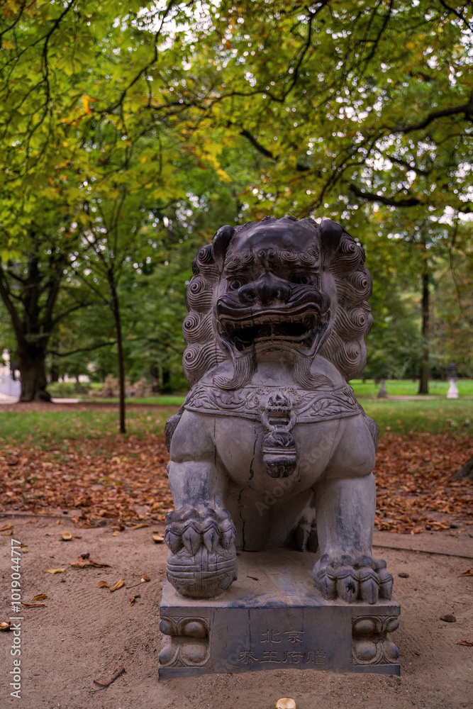 Ancient Stone Lion Statue in Serene Park Setting