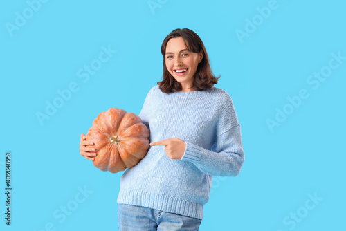 Young woman pointing at pum...