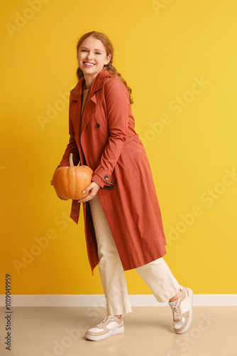 Young woman with pumpkin ne...