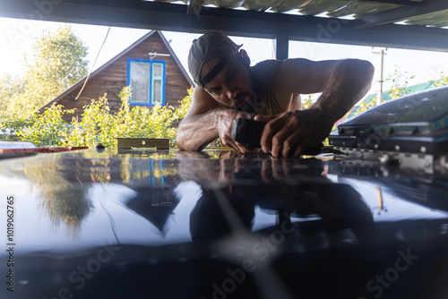 Man With Screwdriver Is Working On Motorhome photo