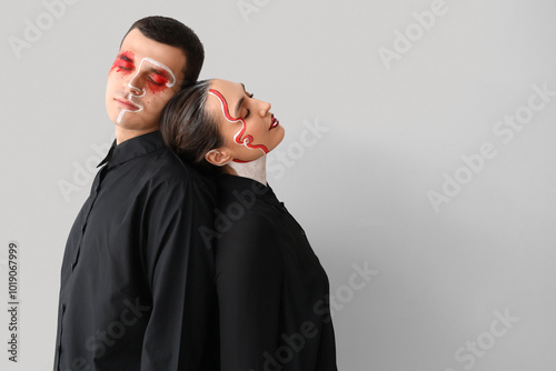 Young couple with painted f...