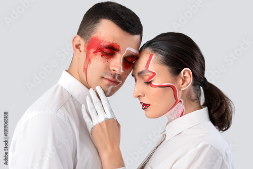 Young couple with painted f...