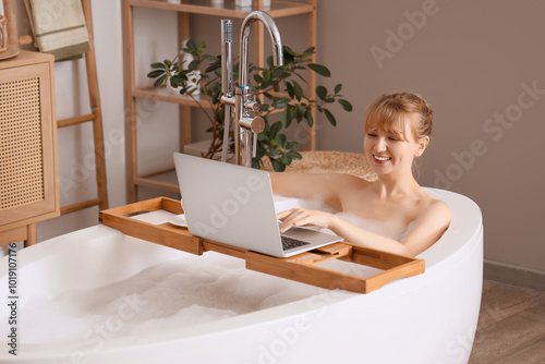 Young woman using laptop on...