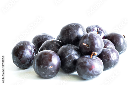 Ripe plums on a white background