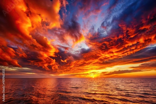 Apocalyptic fiery sky over ocean at dusk