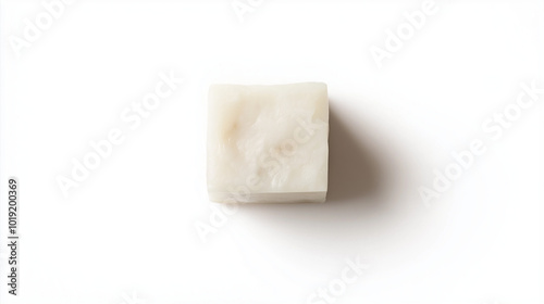 lard concept image: a small chunk of lard, top down view, a small cubie shape of lard placed in the center of a white background