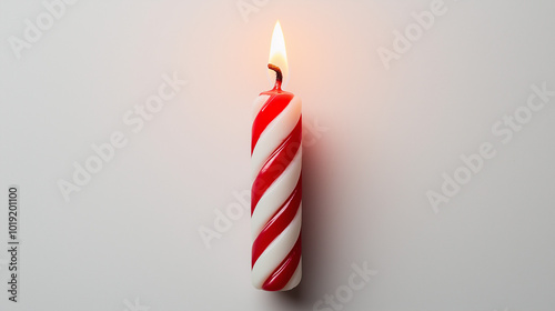 birthday candle concept image: red and white striped candle, top down view, a single birthday candle placed in the center of a white background