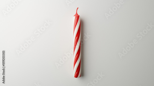 birthday candle concept image: red and white striped candle, top down view, a single birthday candle placed in the center of a white background
