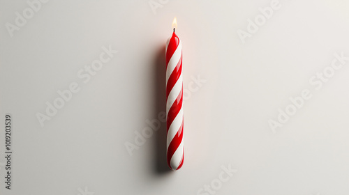 birthday candle concept image: red and white striped candle, top down view, a single birthday candle placed in the center of a white background