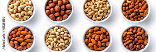 Assortment of nuts in white bowls, including almonds, cashews, and hazelnuts.