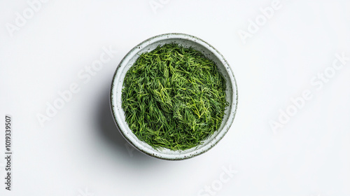 Green Tea Leaves in Bowl: A minimalist photograph of a bowl filled with vibrant green tea leaves, set against a clean white background. The image captures the essence of tranquility and purity.