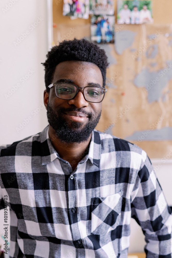 Portrait of smiling young black man looking at camera at home Portrait of smiling young black man looking at camera at home