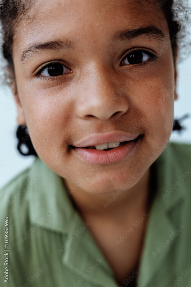 Happy african american boy smiling at the camera with a trendy and confident expression