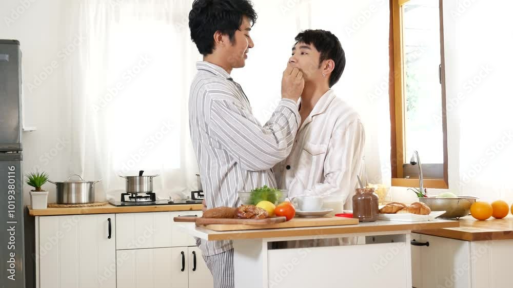 Happy gay couple enjoy breakfast in kitchen drinking coffee. Two best friends LGBTQ relation partner home cooking. Happiness romance homosexual marriage lifestyle. Two men together love friendship. Happy gay couple enjoy breakfast in kitchen drinking coffee. Two best friends LGBTQ relation partner home cooking. Happiness romance homosexual marriage lifestyle. Two men together love friendship.