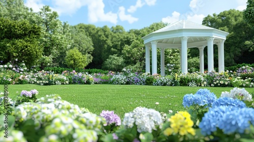 White Gazebo in a Lush Flower Garden with Green Grass and Blue Sky