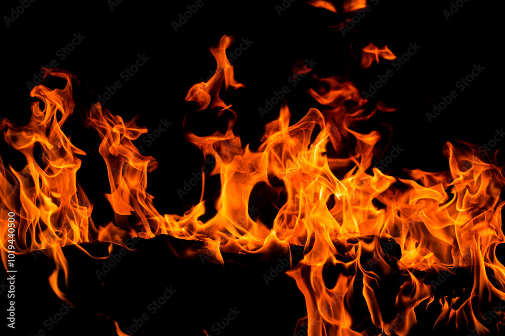 Fire and flames for background. Bright flames background. Texture of fire on a black background. Burning red fire. Large fire in the night. Fire and flames for background. Bright flames background. Texture of fire on a black background. Burning red fire. Large fire in the night.