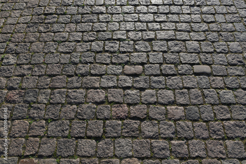 Stone road background texture. Textured background of cobblestone road. Road from brick background. Paving stone and paved road. Sidewalk background.