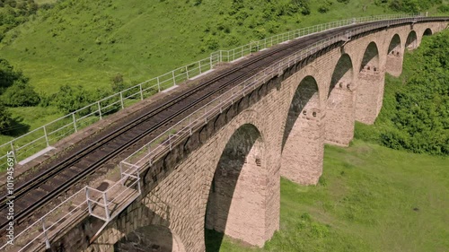 Aerial view of an old railway viaduct, Austro-Hungarian railway bridge in the village of Plebanivka in the Ternopil region of Ukraine, Travel sight points in Ukraine. 4k video photo